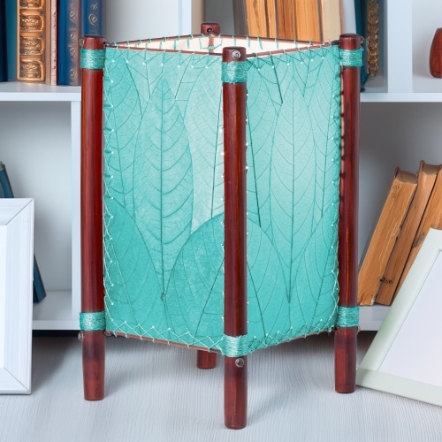 Square Fortune series table lamp crafted by Eangee Home Design wrapped in sea blue fossilized cocoa leaves, abaca?stitched edges, rattan legs; geometric lines softened as cozy light radiates against the leaf?veined surface; fair?trade craftsmanship using sustainable resources