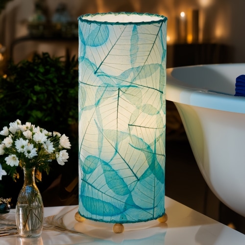 Banyan?inspired table lamp crafted by Eangee Home Design woven with sea blue fossilized cocoa leaves between wrought?iron ribs; branching silhouette highlights leaf texture while soothing light filters through every vein; sustainably handcrafted by skilled artisans