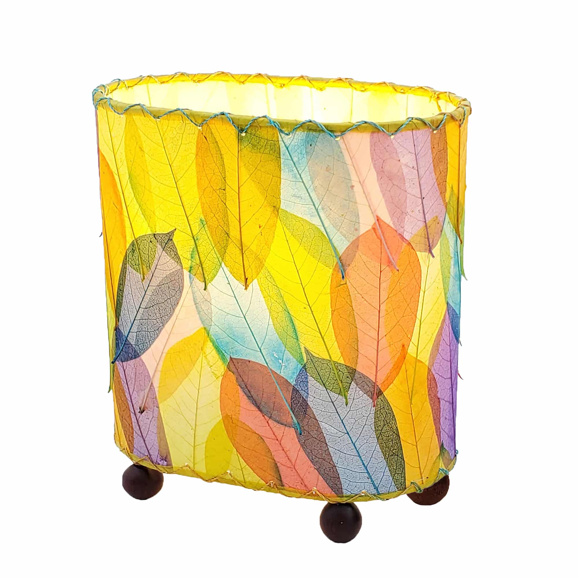 Crafted by the artisans of Eangee Home Design, the Mini Guyabano Table Lamp in multi color against a clean backdrop, featuring fossilized cocoa leaf shade, guyabano leaf shade, wrought iron frame.