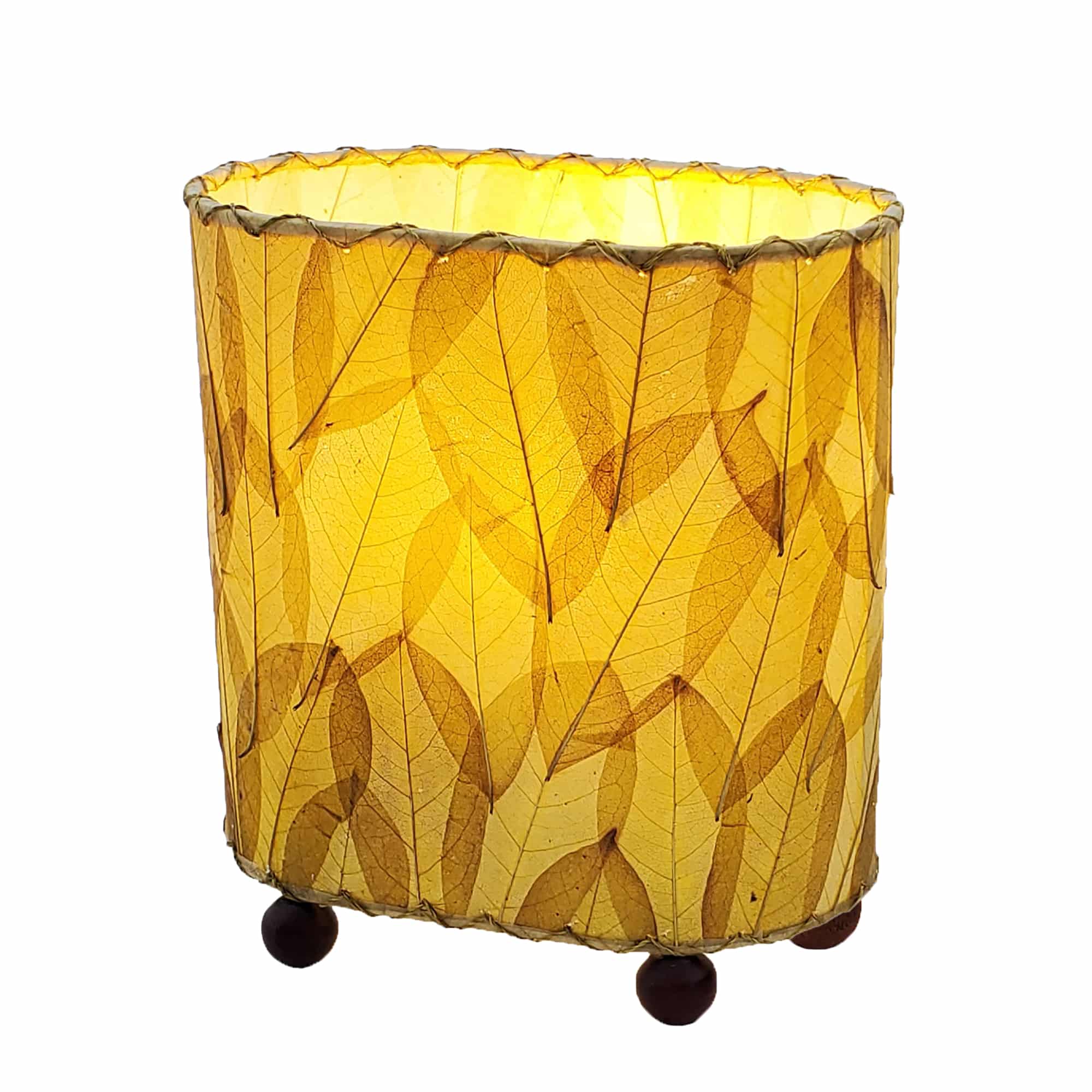 Crafted by the artisans of Eangee Home Design, the Mini Guyabano Table Lamp in natural against a clean backdrop, featuring fossilized cocoa leaf shade, guyabano leaf shade, wrought iron frame.