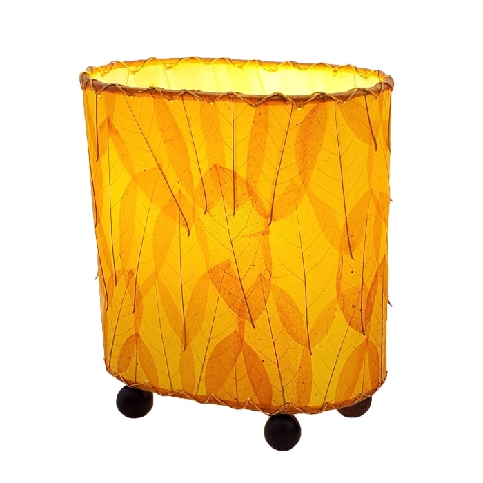 Crafted by the artisans of Eangee Home Design, the Mini Guyabano Table Lamp in orange against a clean backdrop, featuring fossilized cocoa leaf shade, guyabano leaf shade, wrought iron frame.