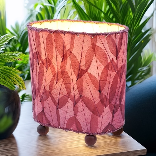Crafted by the artisans of Eangee Home Design, the Mini Guyabano Table Lamp in purple against a clean backdrop, featuring fossilized cocoa leaf shade, guyabano leaf shade, wrought iron frame.
