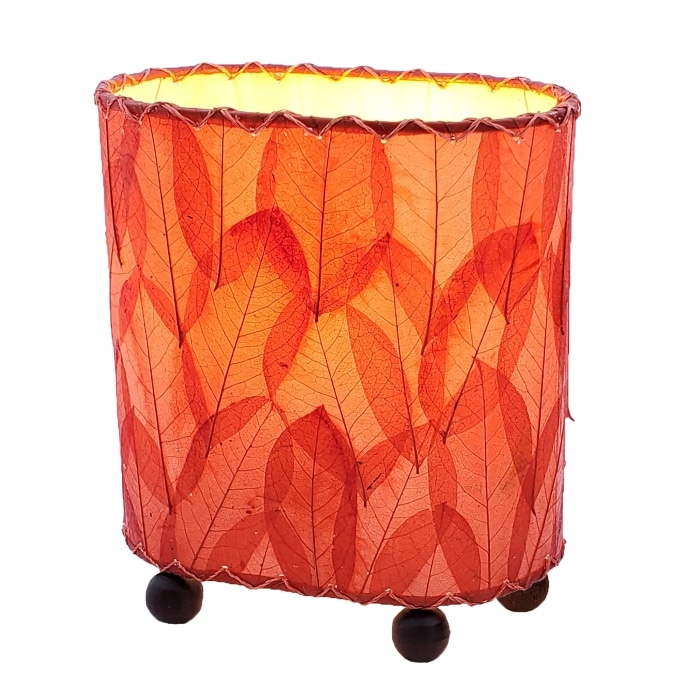 Crafted by the artisans of Eangee Home Design, the Mini Guyabano Table Lamp in red against a clean backdrop, featuring fossilized cocoa leaf shade, guyabano leaf shade, wrought iron frame.