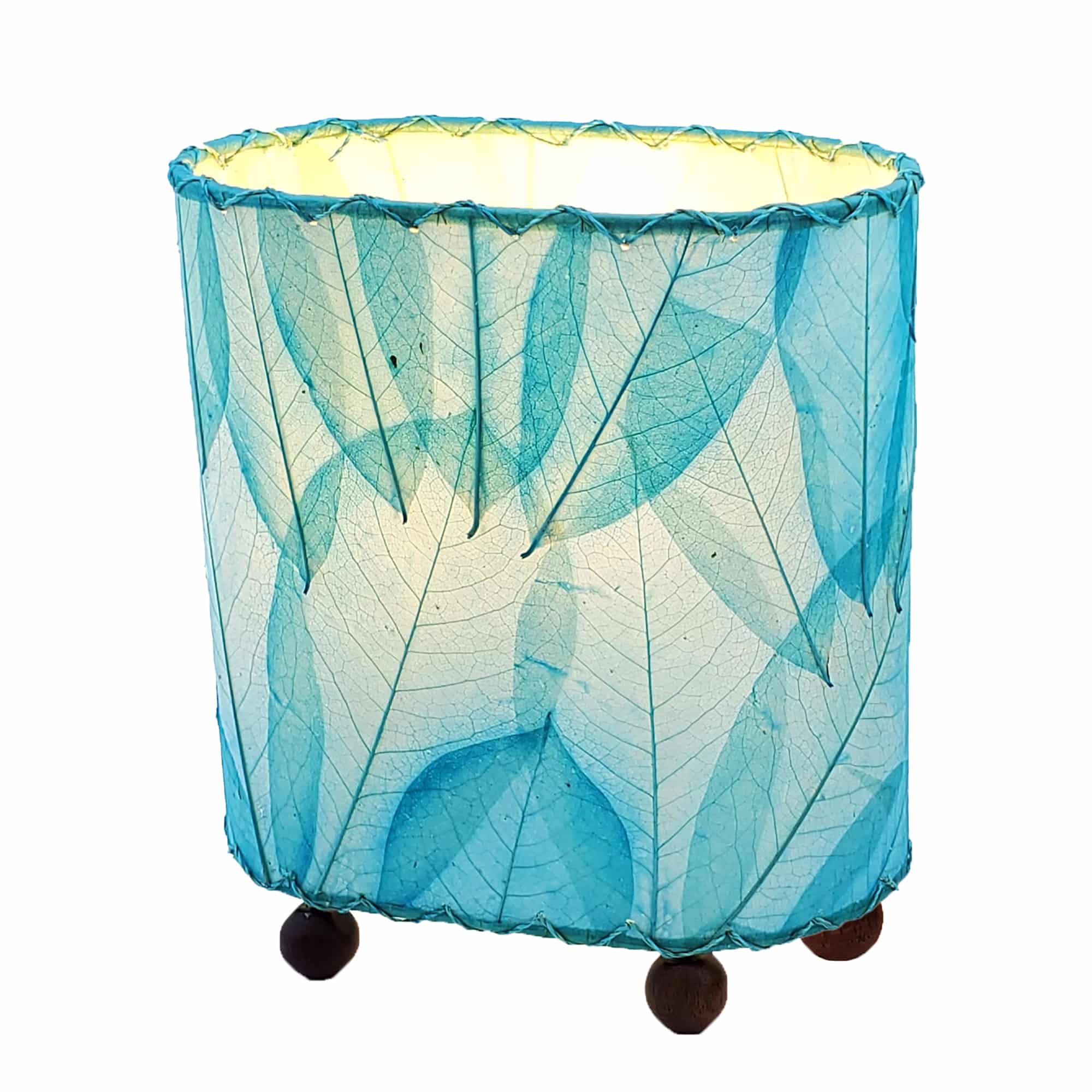 Crafted by the artisans of Eangee Home Design, the Mini Guyabano Table Lamp in sea blue against a clean backdrop, featuring fossilized cocoa leaf shade, guyabano leaf shade, wrought iron frame.