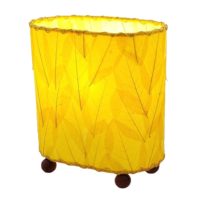 Crafted by the artisans of Eangee Home Design, the Mini Guyabano Table Lamp in yellow against a clean backdrop, featuring fossilized cocoa leaf shade, guyabano leaf shade, wrought iron frame.
