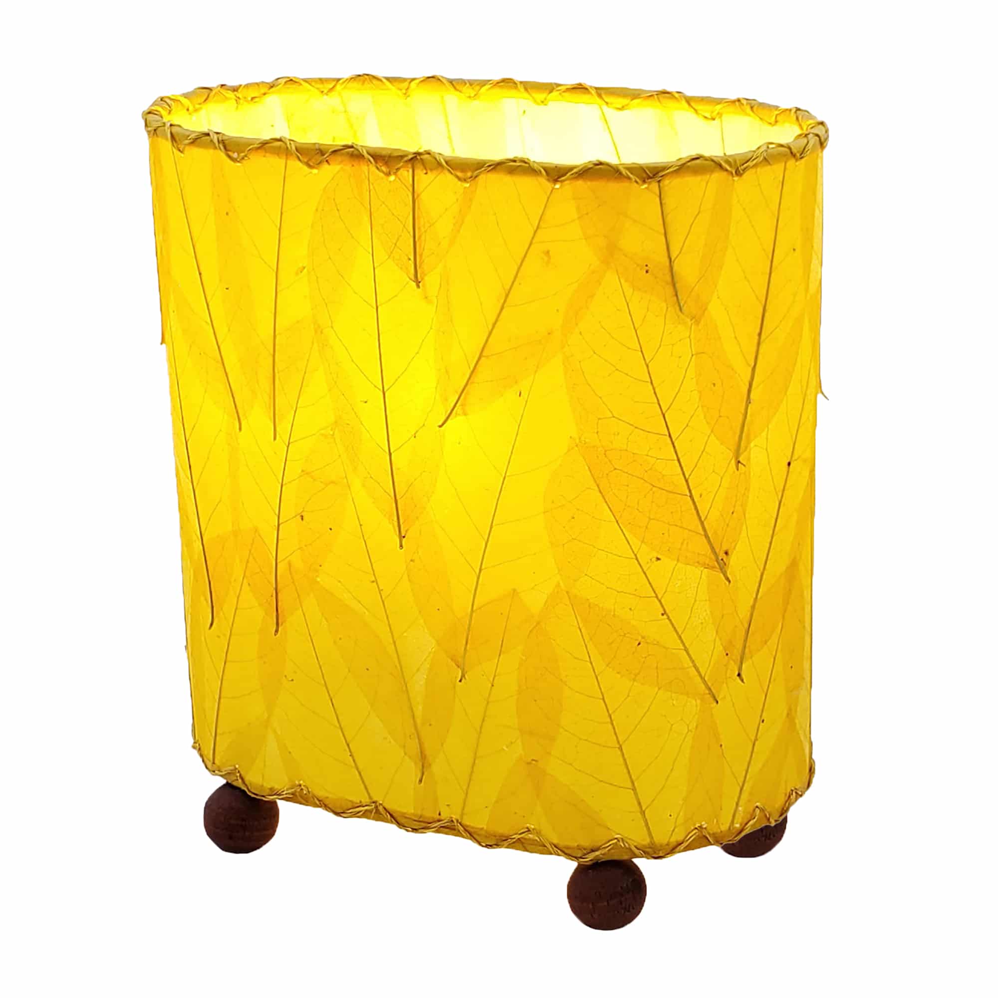 Crafted by the artisans of Eangee Home Design, the Mini Guyabano Table Lamp in yellow against a clean backdrop, featuring fossilized cocoa leaf shade, guyabano leaf shade, wrought iron frame.