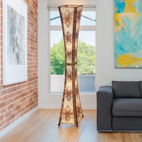 In a sun drenched entryway, crafted by the artisans of Eangee Home Design, the Hourglass Giant Floor Lamp in natural stands gracefully, featuring jackfruit leaf panels, abaca rope accents, wrought iron frame, eco friendly, handcrafted, adding warmth and character to the space.