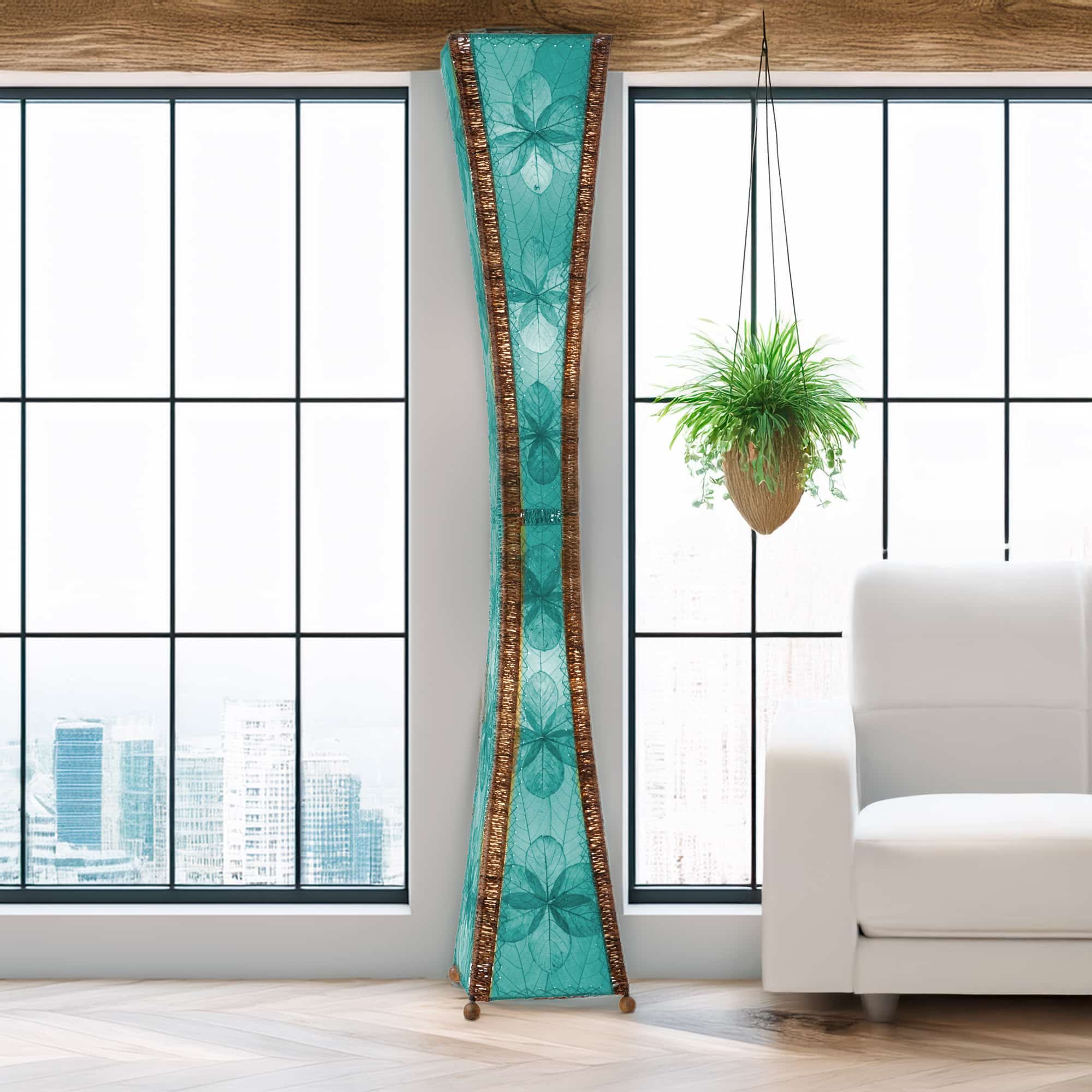 In a softly lit reading nook, crafted by the artisans of Eangee Home Design, the Hourglass Giant Floor Lamp in sea blue stands gracefully, featuring jackfruit leaf panels, abaca rope accents, wrought iron frame, eco friendly, handcrafted, adding warmth and character to the space.