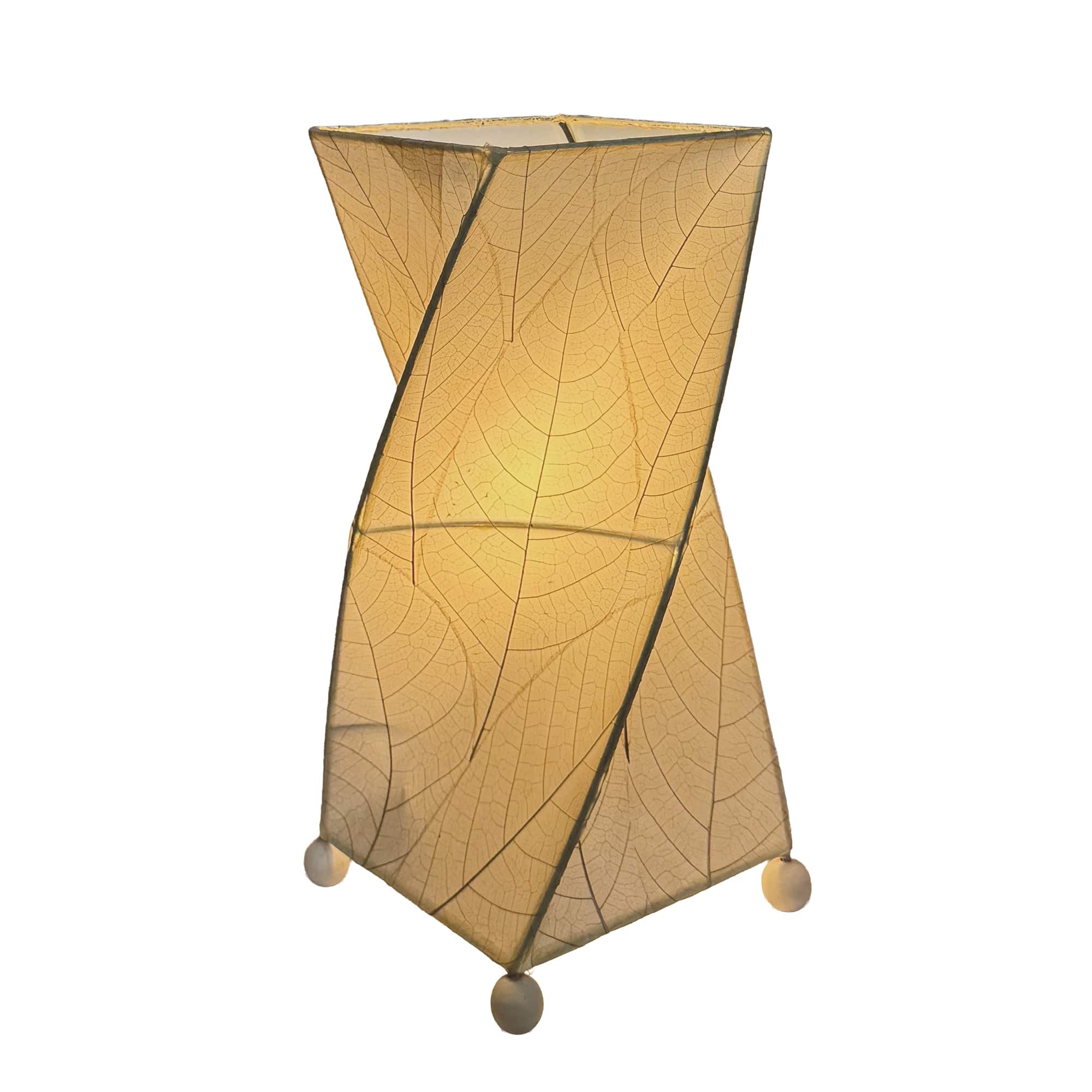 Crafted by the artisans of Eangee Home Design, the Twist Table Lamp in natural against a clean backdrop, featuring fossilized cocoa leaf shade, wrought iron frame, handcrafted.