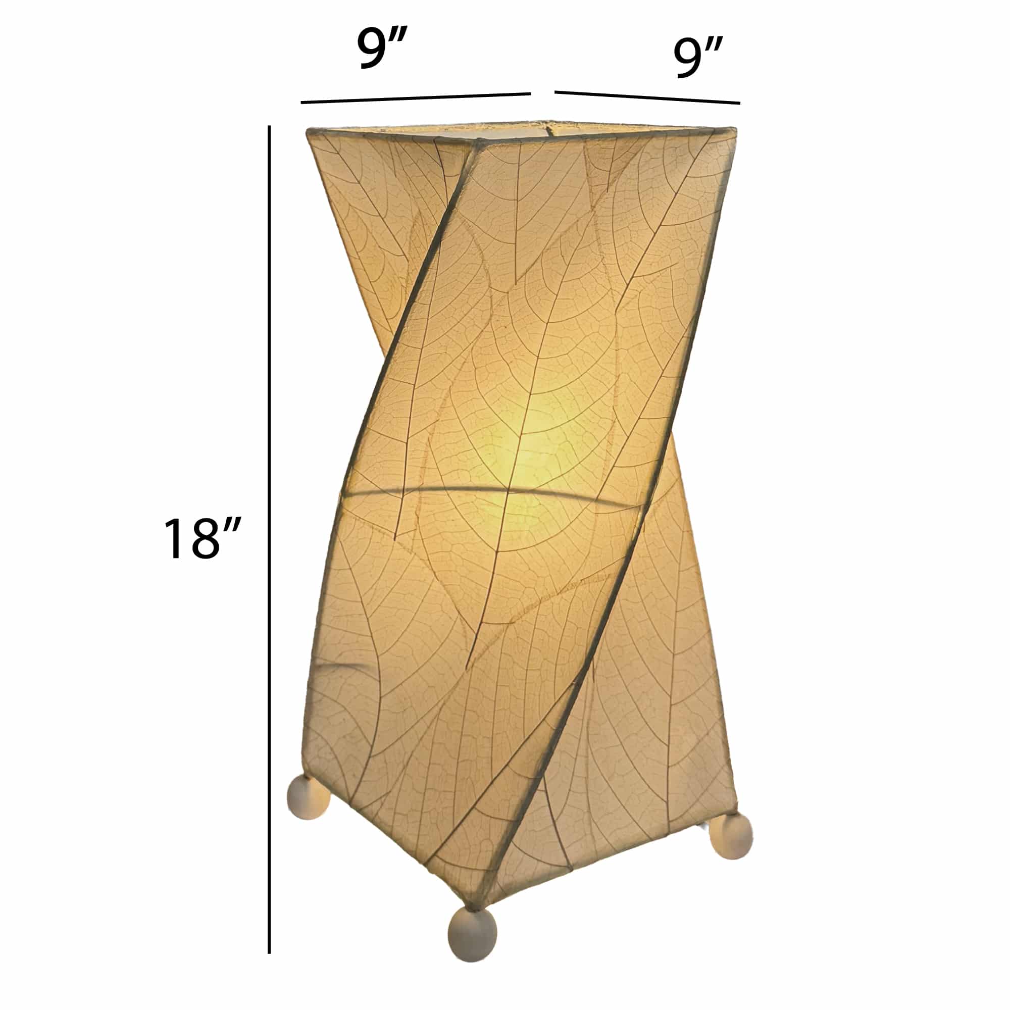 Crafted by the artisans of Eangee Home Design, the Twist Table Lamp in natural against a clean backdrop, featuring fossilized cocoa leaf shade, wrought iron frame, handcrafted.
