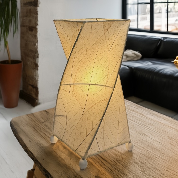 Twisted cube table lamp crafted by Eangee Home Design clad in vertical natural fossilized cocoa leaves; 90?degree rotation adds dynamism while cozy light spills through every vein; sustainably handcrafted by skilled artisans