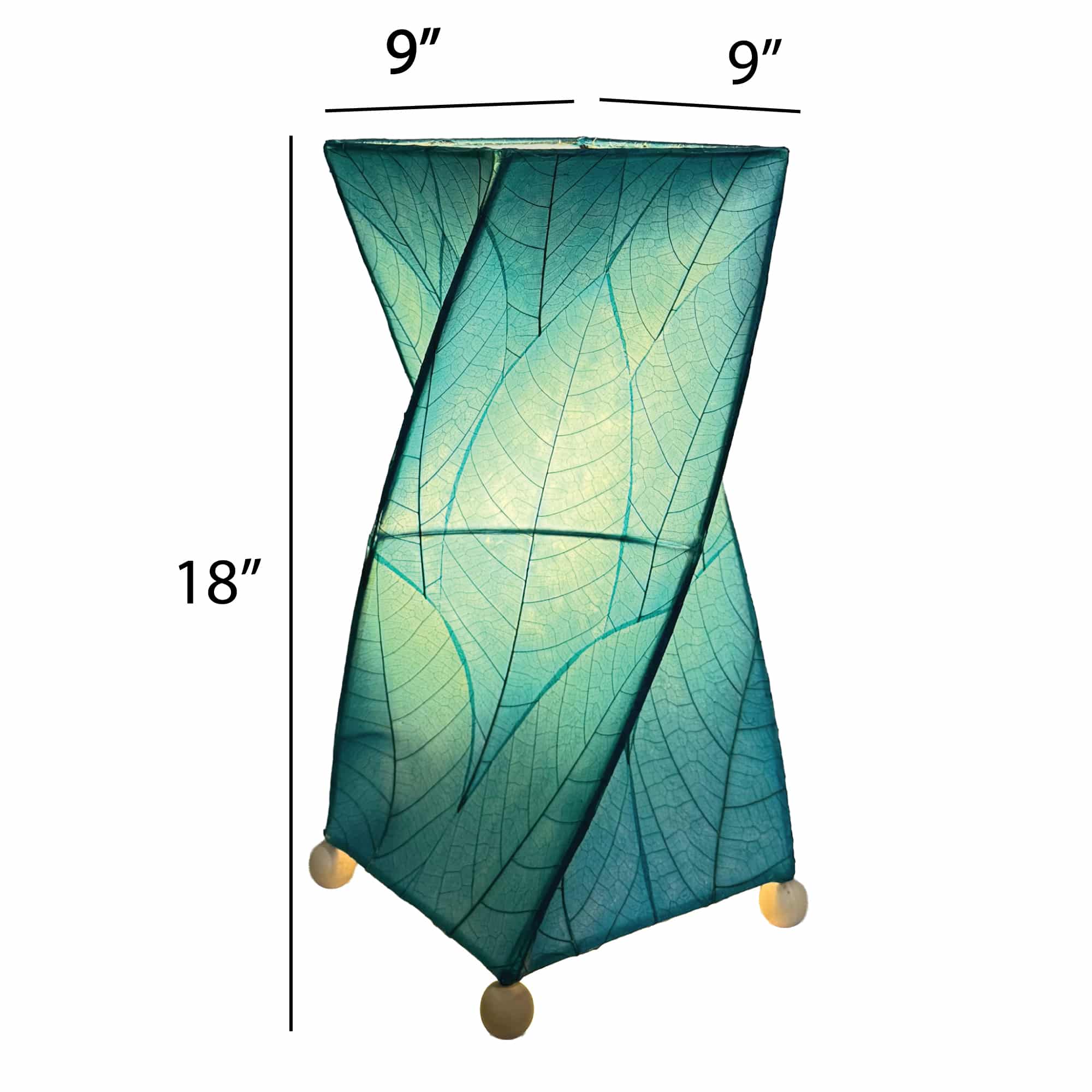 Crafted by the artisans of Eangee Home Design, the Twist Table Lamp in sea blue against a clean backdrop, featuring fossilized cocoa leaf shade, wrought iron frame, handcrafted.