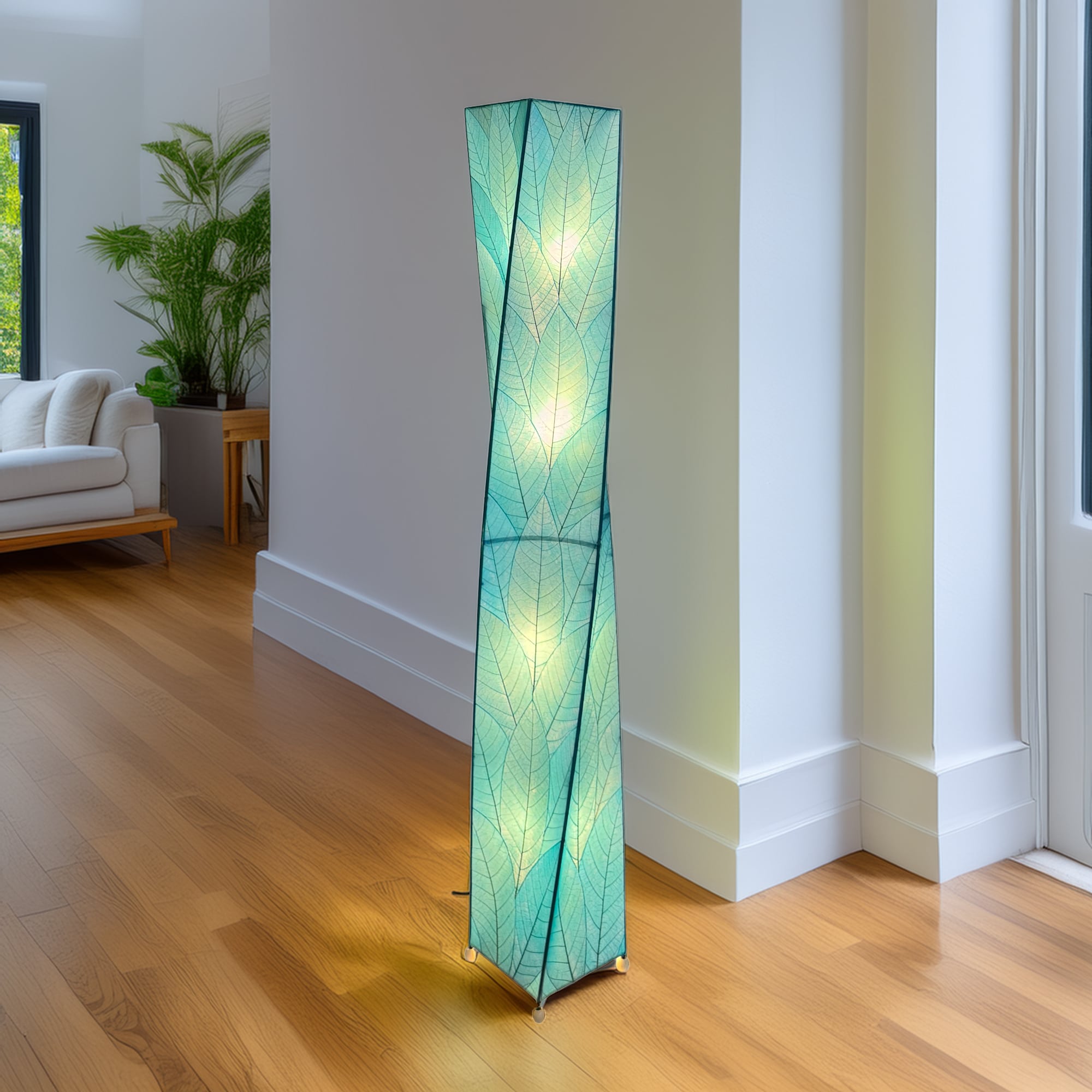 Crafted by the artisans of Eangee Home Design, the Twist Giant Floor Lamp in sea blue against a clean backdrop, featuring fossilized cocoa leaf shade, wrought iron frame.