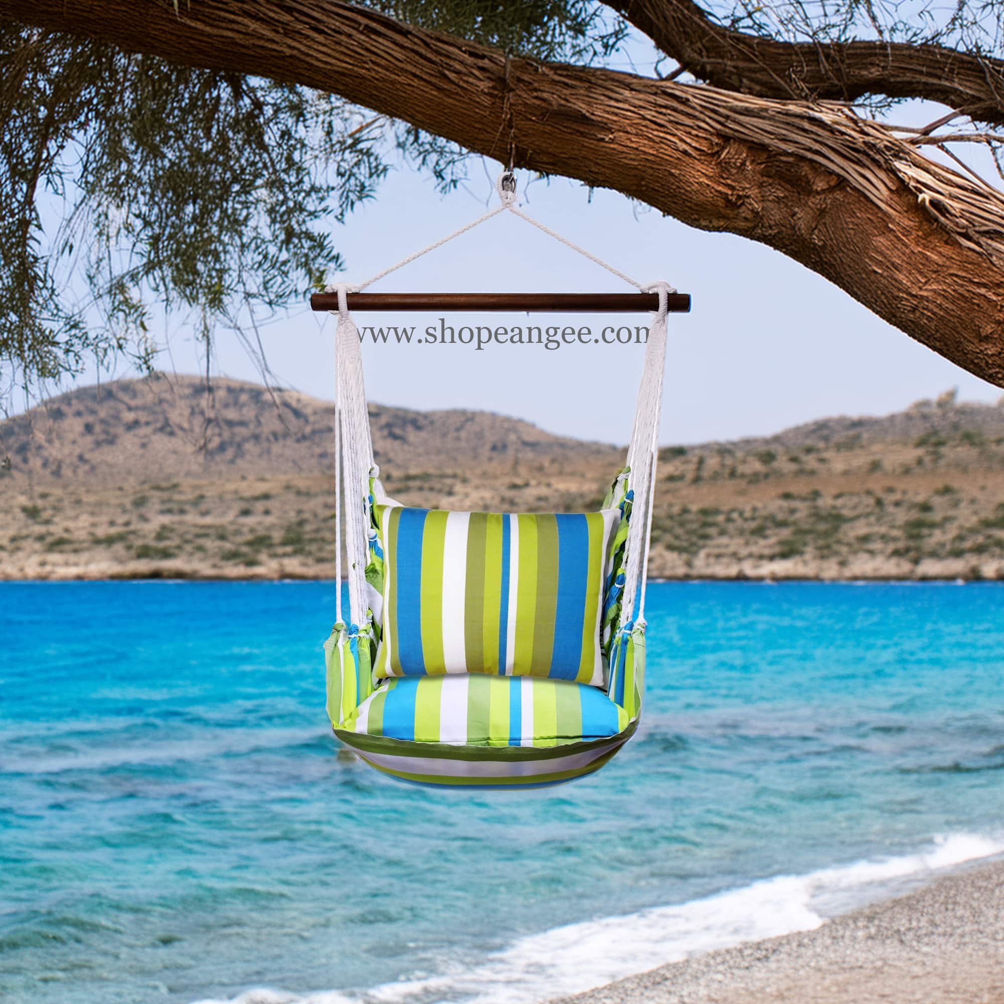 In a cozy garden seating area a multi colored outdoor swing crafted by the artisans of Magnolia Casual called the Swing Set 4 piece Beach Boulevard Stripe w/ Beach Boulevard Stripe is displayed featuring 100 percent weather resistant fabric, weather resistant polyester fabric adding comfort and style to the space featuring with a stripe motif.
