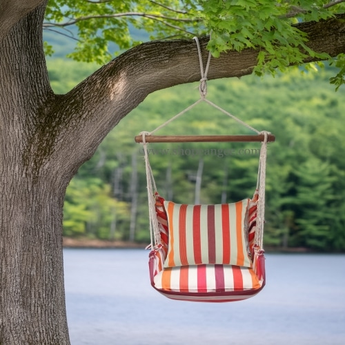 In a cozy garden seating area a multi colored outdoor swing crafted by the artisans of Magnolia Casual called the Swing Set 4 piece Cristina Stripe w/ Cristina Stripe is displayed featuring 100 percent weather resistant fabric, weather resistant polyester fabric, handcrafted adding comfort and style to the space featuring with a stripe motif.