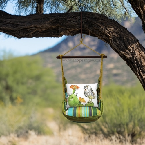 In a shaded porch swing a multi colored outdoor swing crafted by the artisans of Magnolia Casual called the Swing Set 4 piece Citrus Stripe w/ Owl on Prickly Cactus is displayed featuring 100 percent weather resistant fabric, weather resistant polyester fabric, handcrafted adding comfort and style to the space featuring with a stripe motif.