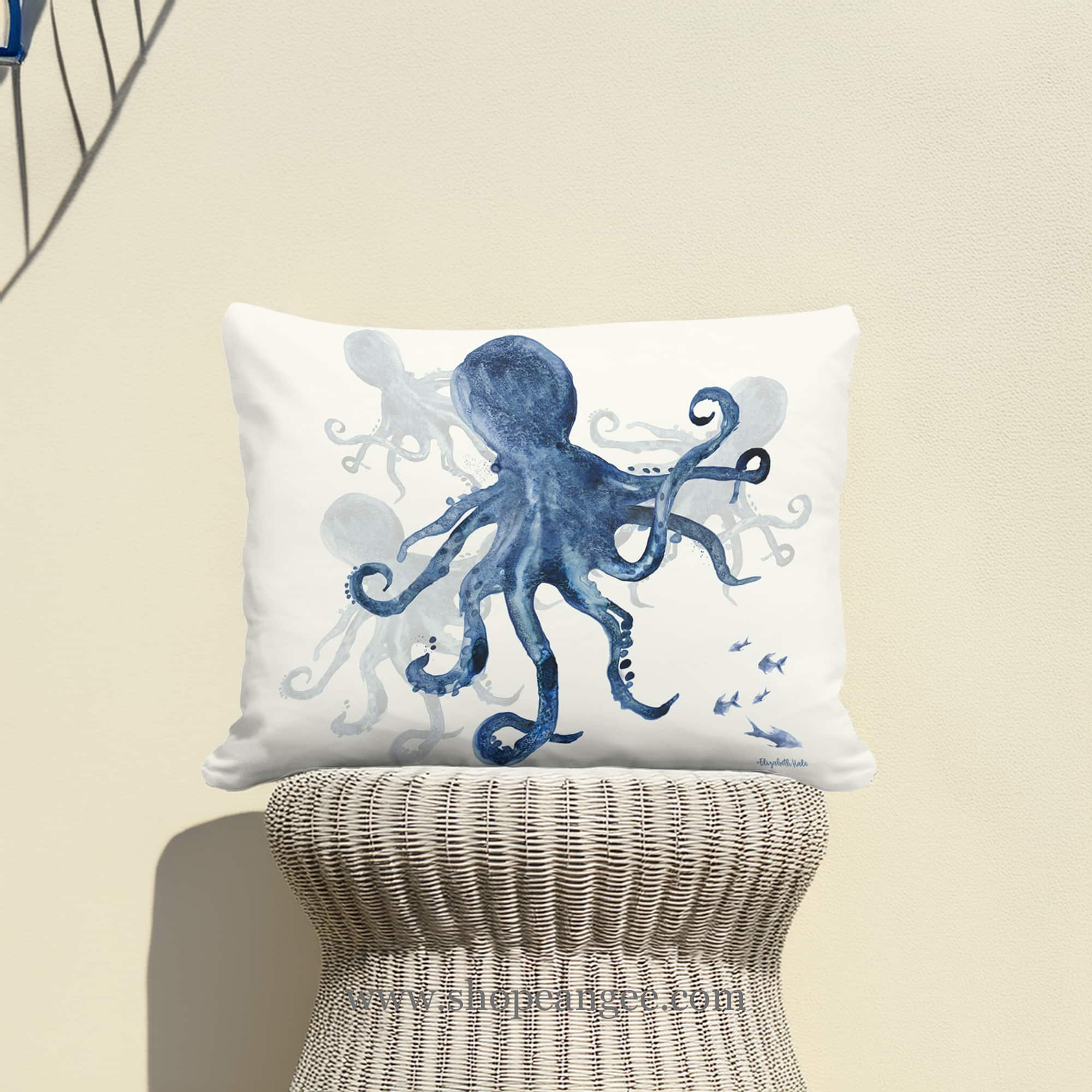 In a coastal inspired deck chair a multi colored outdoor pillow crafted by the artisans of Magnolia Casual called the Outdoor Pillow Indigo Octopus 19x24 is displayed featuring quality outdoor fabric adding comfort and style to the space featuring with a octopus motif.