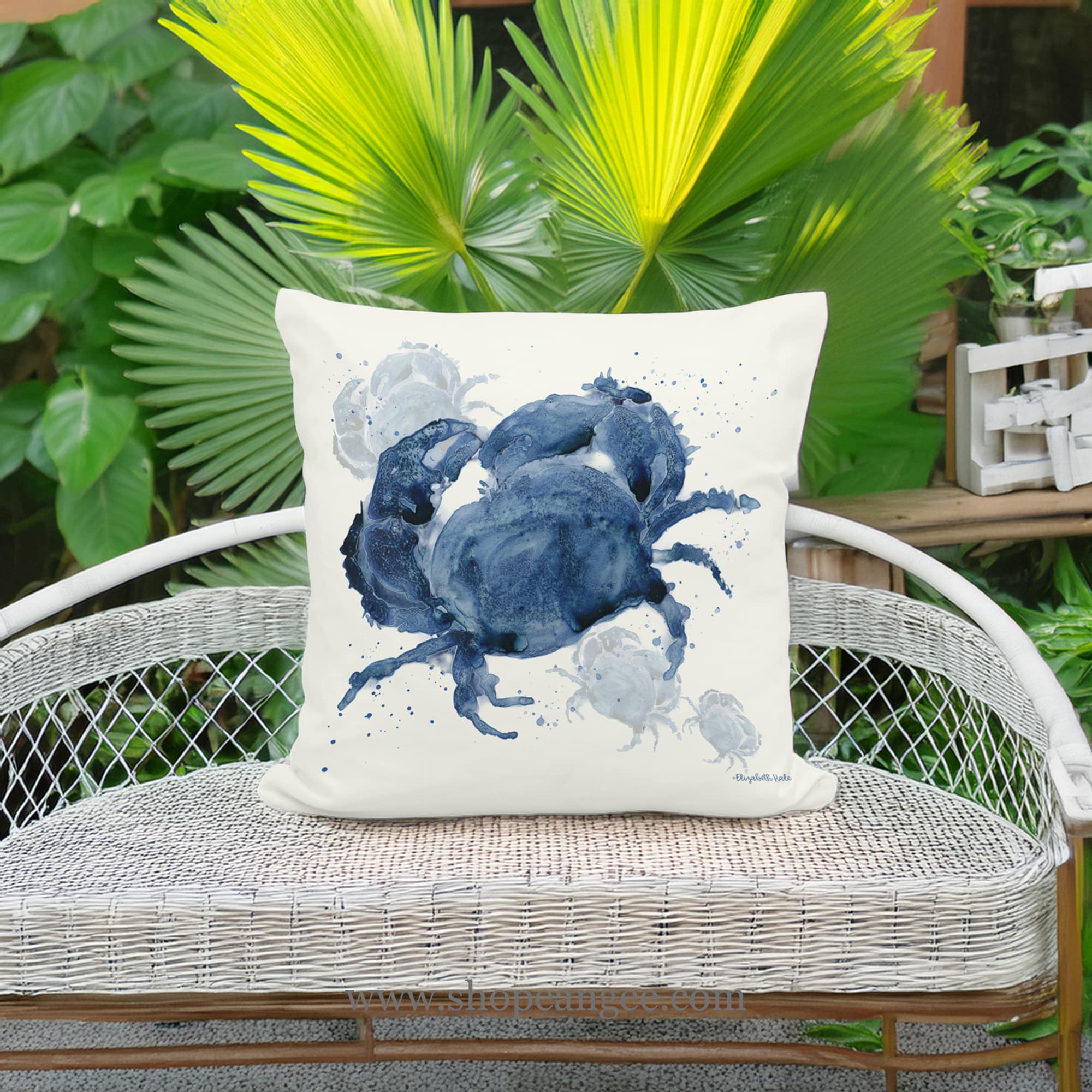 In a cozy garden seating area a multi colored outdoor pillow crafted by the artisans of Magnolia Casual called the Outdoor Pillow Indigo Crab 18x18 is displayed featuring quality outdoor fabric adding comfort and style to the space featuring with a crab motif.