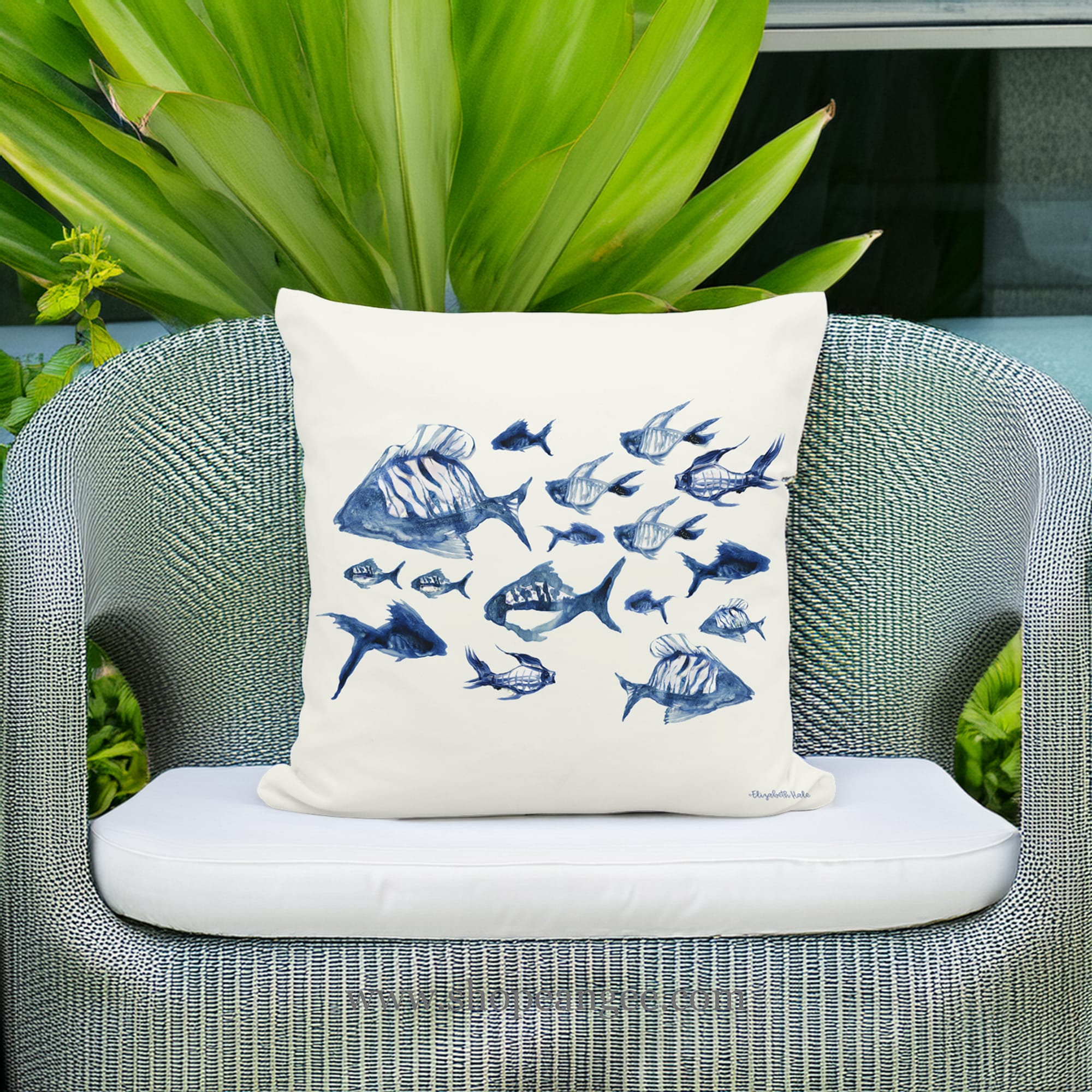In a coastal inspired deck chair a multi colored outdoor pillow crafted by the artisans of Magnolia Casual called the Outdoor Pillow Underwater Ballet 18x18 is displayed featuring quality outdoor fabric adding comfort and style to the space.