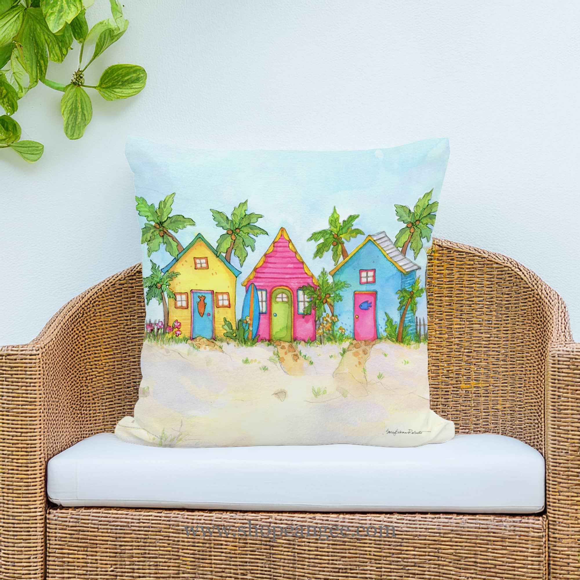 In a coastal inspired deck chair a multi colored outdoor pillow crafted by the artisans of Magnolia Casual called the Outdoor Pillow Colorful Beach Cottages 18x18 is displayed featuring quality outdoor fabric, eco friendly adding comfort and style to the space.