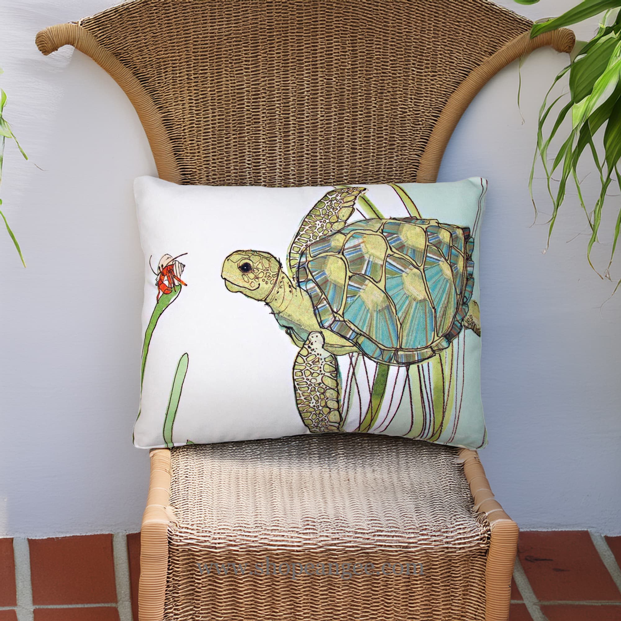 In a poolside chaise a sea outdoor pillow crafted by the artisans of Magnolia Casual called the Outdoor Pillow Sea Turtle 19x24 is displayed featuring quality outdoor fabric adding comfort and style to the space featuring with a sea turtle motif.