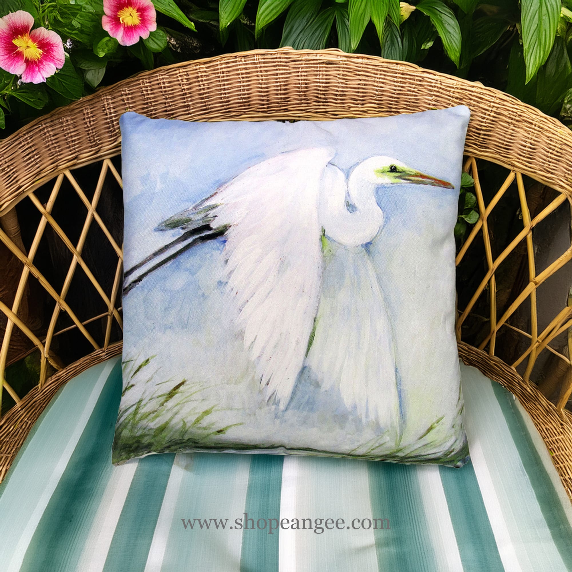 In a shaded porch swing a white outdoor pillow crafted by the artisans of Magnolia Casual called the Outdoor Pillow White Egret Flying 18x18 is displayed featuring quality outdoor fabric adding comfort and style to the space featuring shades of white.