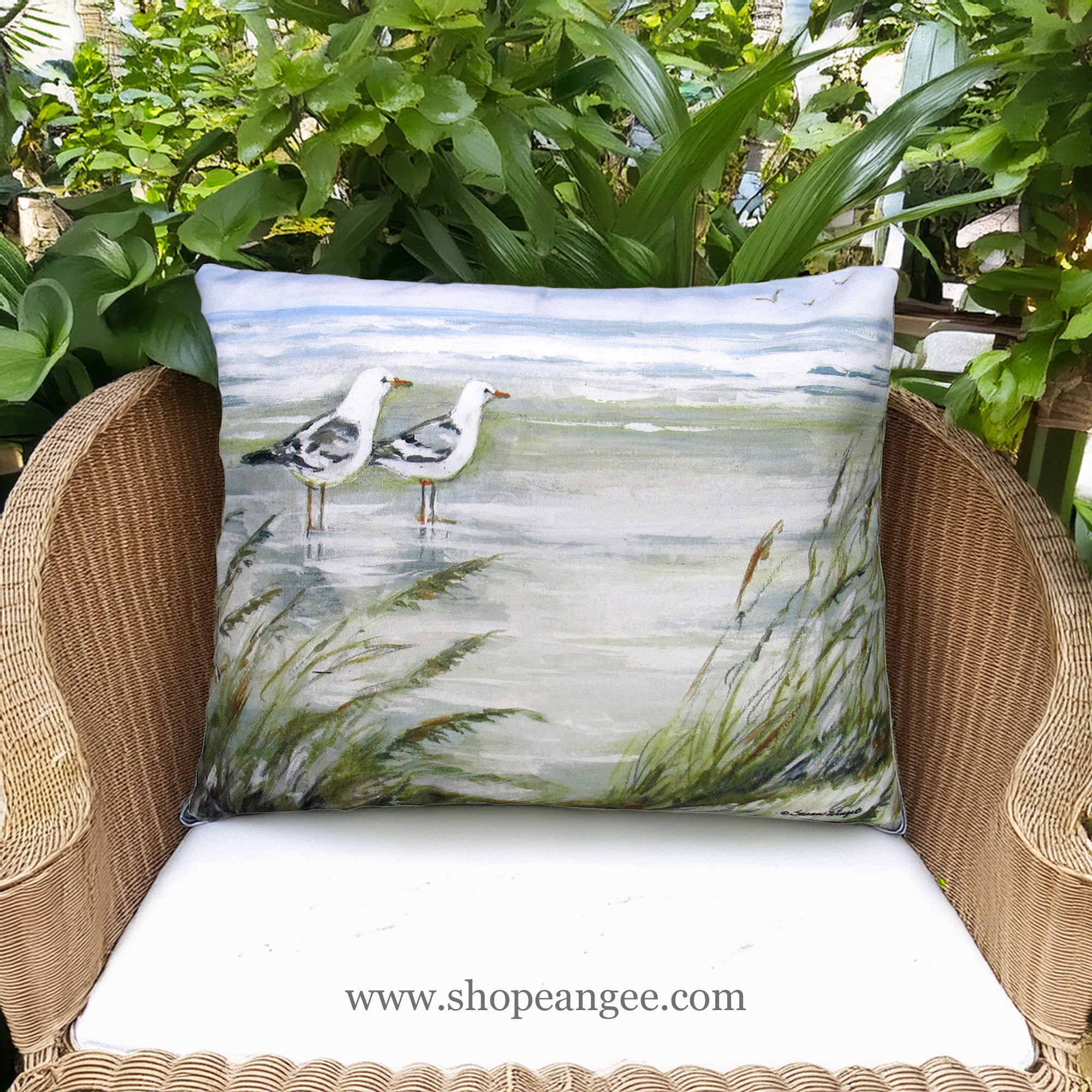 In a coastal inspired deck chair a multi colored outdoor pillow crafted by the artisans of Magnolia Casual called the Outdoor Pillow Seagulls on Beach 19x24 is displayed featuring quality outdoor fabric adding comfort and style to the space.