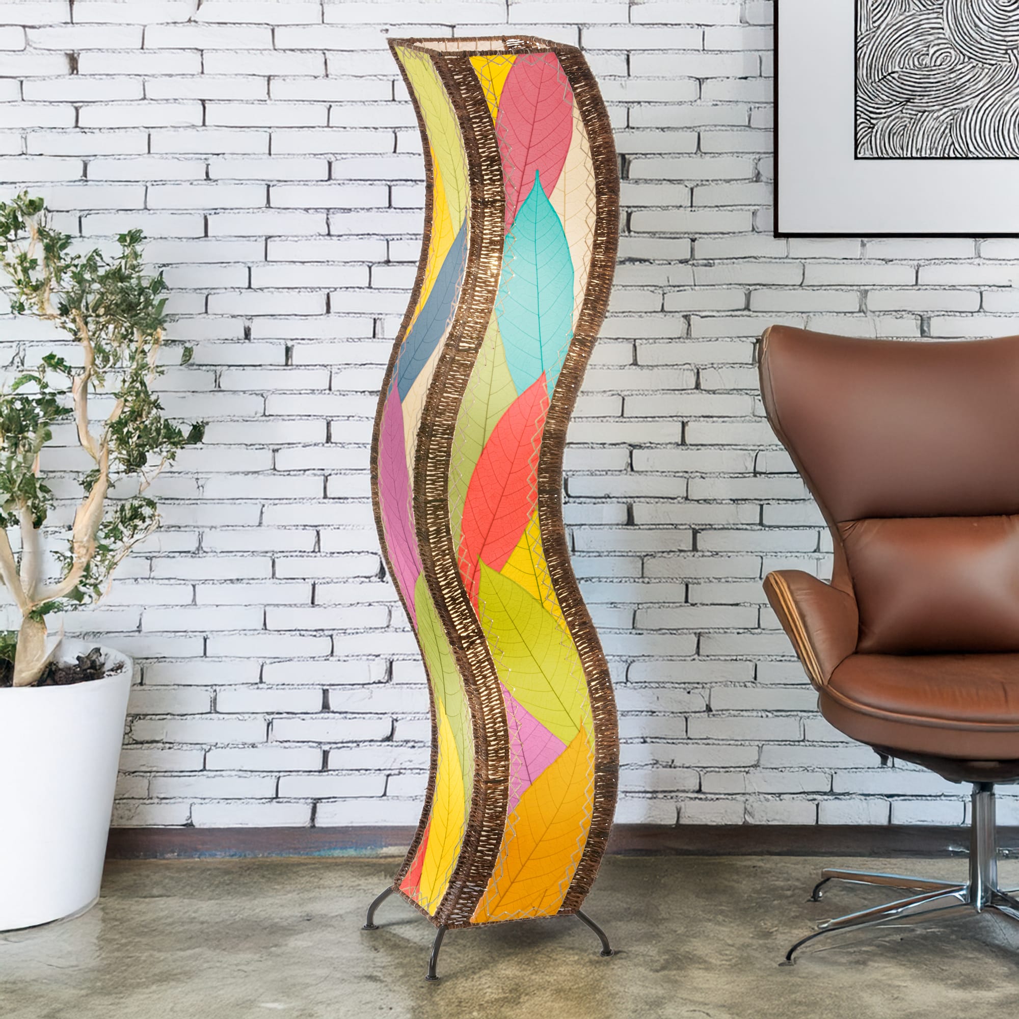 Multicolor Wave Large Floor Lamp by Eangee Home Design - curving sculptural column clad in overlapping fossilized cocoa leaf panels; handmade lamp casts vibrant leaf-textured light that energizes the space.