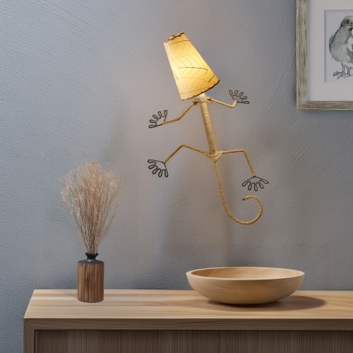 Eangee Home Design Gecko Wall Sconce in natural beige with a shade made of real cocoa leaves, whimsical lizard?shaped lamp climbing a neutral wall above modern decor