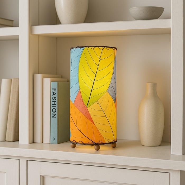 12 Inch Cocoa Leaf Cylinder Table Lamp Multi Color shade, handcrafted from real cocoa leaves . soft ambient light on an entry console beneath a round mirror with catchall dish.