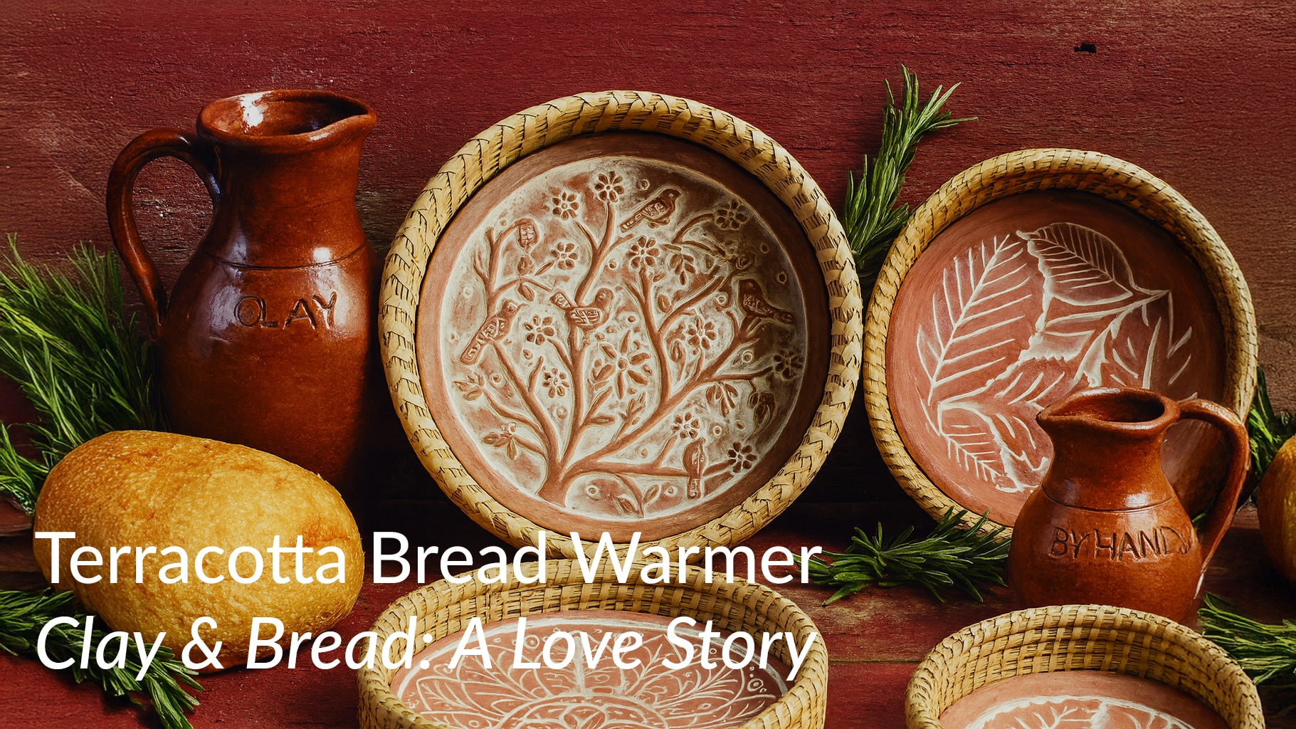 Horizontal photograph of a terracotta bread warmer inside a 3.5-inch deep woven basket, surrounded by rustic clay jugs, fresh herbs, and bread on a wooden table, highlighting the global history of clay and bread.