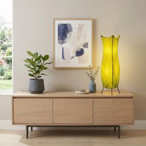 Biophilic design at home with a green leaf lamp, warm light, natural wood, indoor plant, and organic shapes
